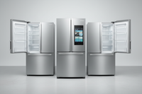 Three stainless steel refrigerators with open doors on a white background